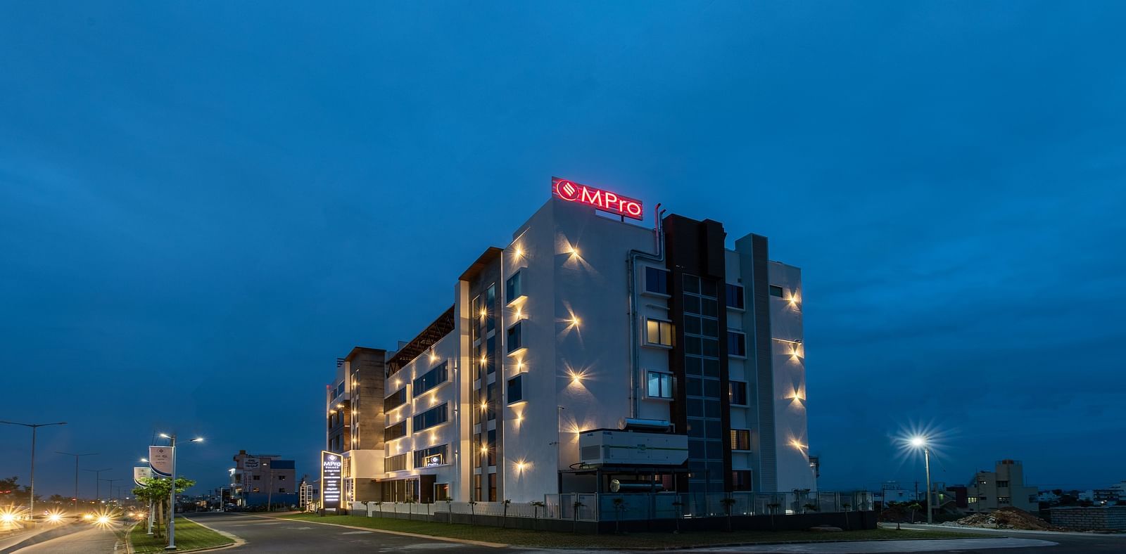 Facade of M Pro Palace with a clear sky in the background.