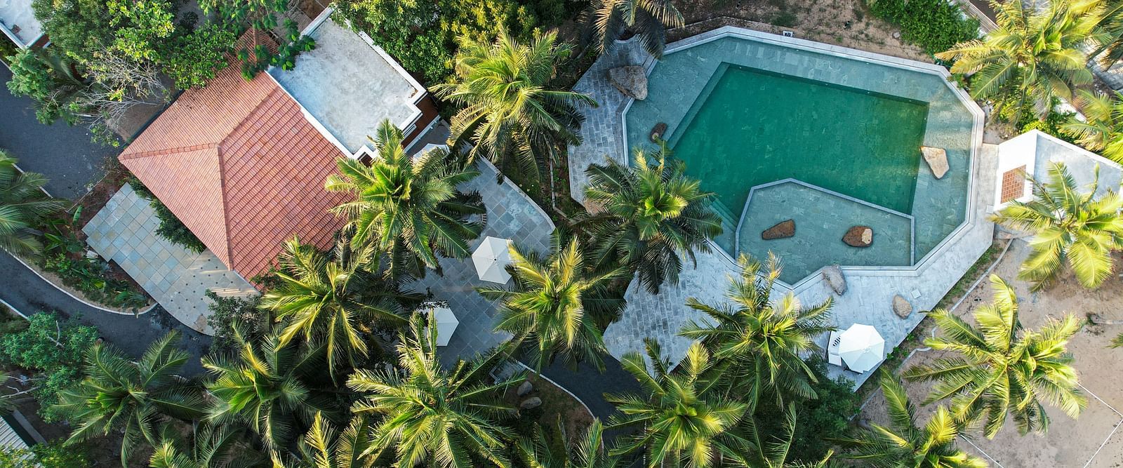Aerial view of a private beach resort near Pondicherry with a swimming pool | Mango Hill Shallow Beach Resort ECR