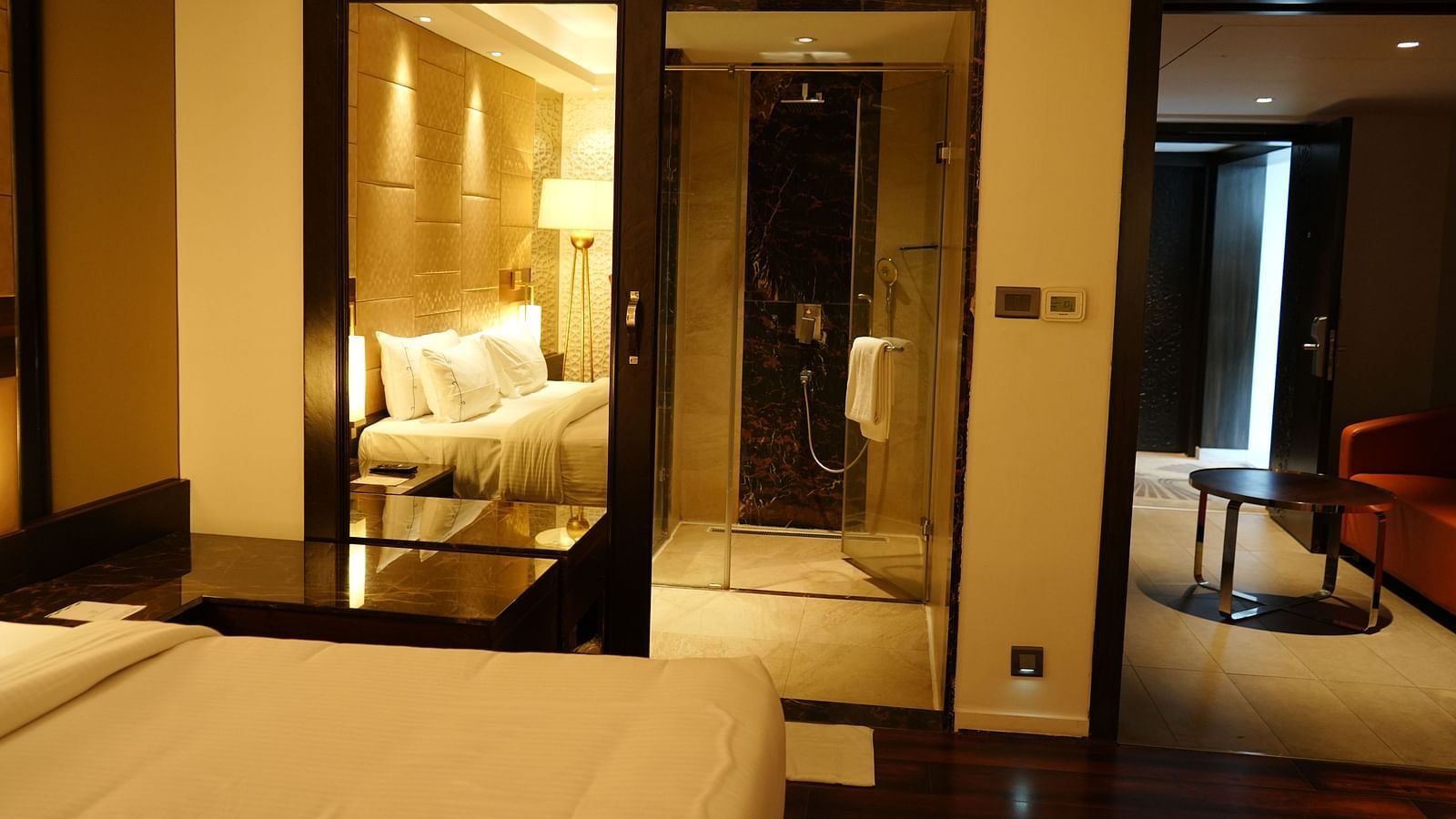 A view of the room featuring a bed and a separate living area with a sofa and table at Cenneys Gateway.