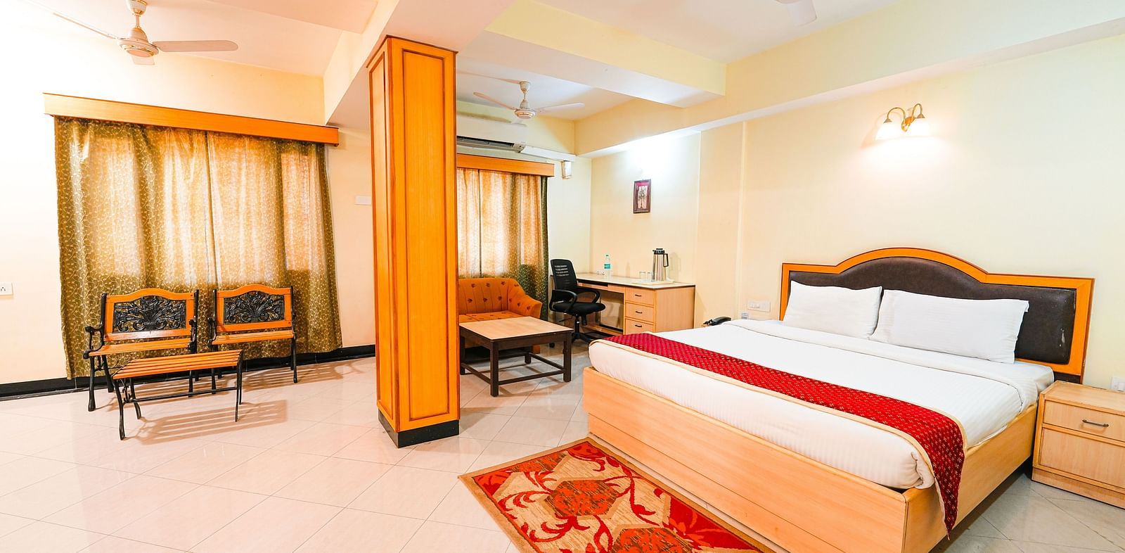 Room at Vasundhara Villa with a double bed and seating