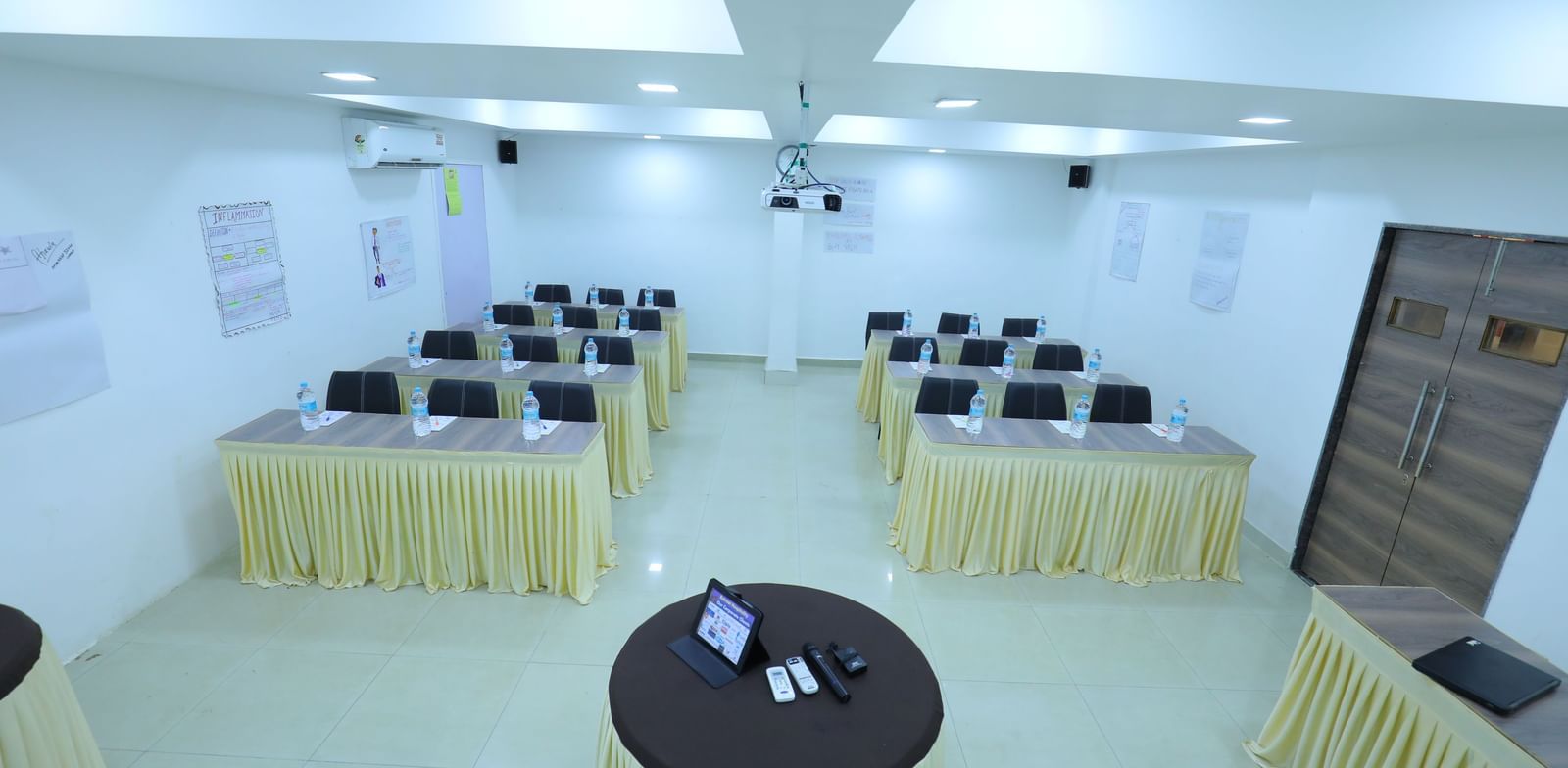 Classroom seating arrangement, projector, air-conditioning in the spacious Olive banquet hall, with ample lighting, at Highland Resort.