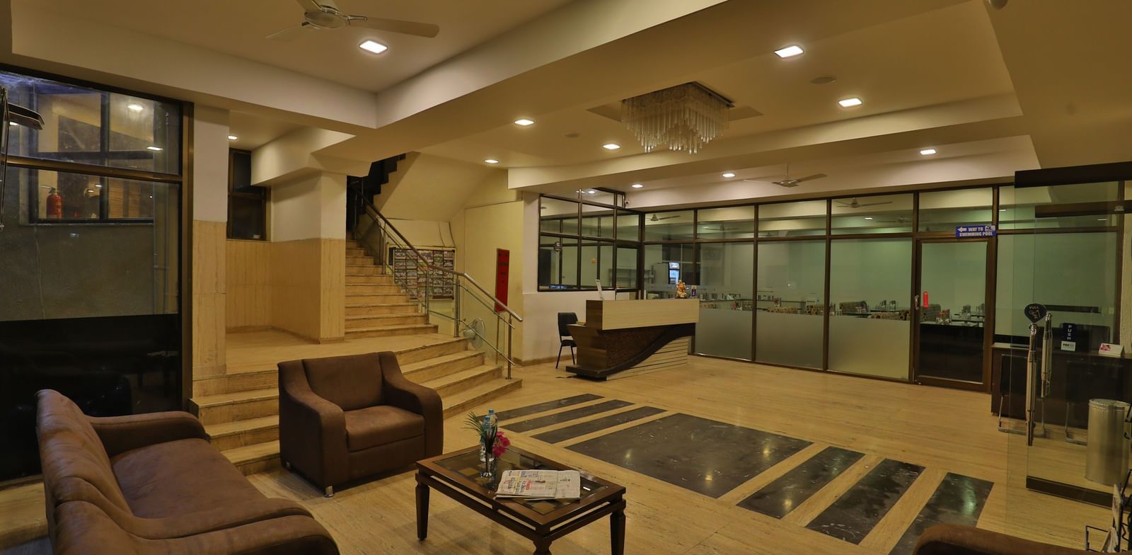A hotel lobby and lounge area with stylish seating, wooden accents, and contemporary lighting - Retreat Heritage, Lonavala