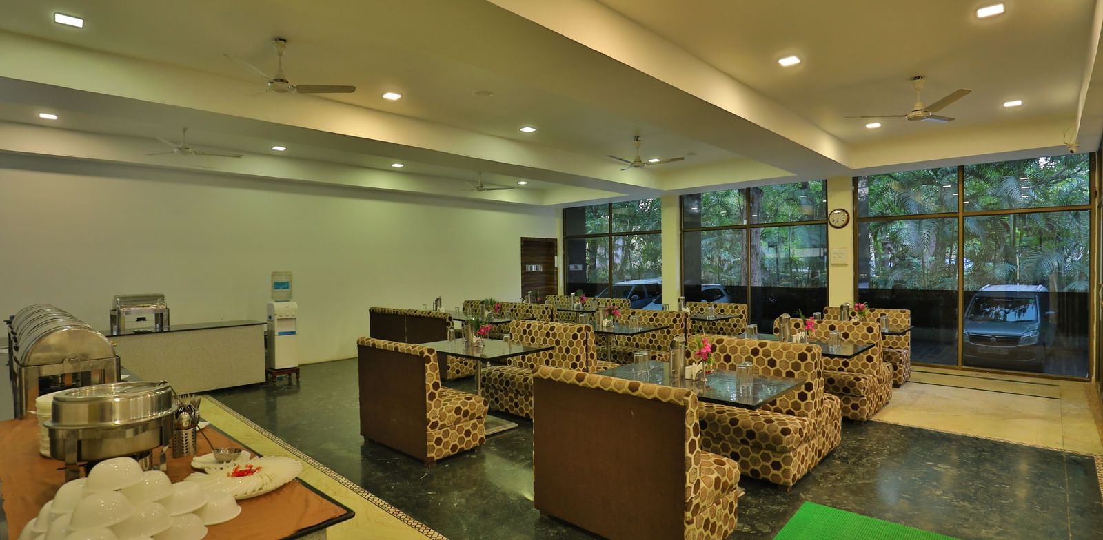 A large dining area with various seating areas, including sofas and low tables, and warm lighting - Retreat Heritage, Lonavala