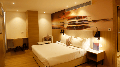 A suite with a king size bed with minimalistic decor and modern lighting - Tulip Inn, Zirakpur