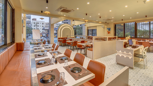 Wide view of the dining area with table settings and open layout at VITS Select Nashik Hotels & Resorts.