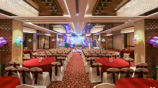 Front view of Blossom Hall with stylish decor, lights, and chairs at Icon Premier Hotel by Bhagini, Devarabisanahalli