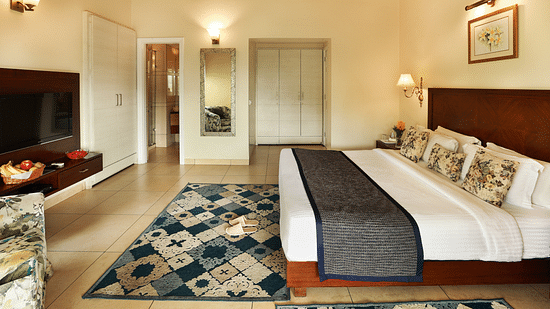 Full angle view of Super deluxe room featuring a white cupboard and other room amenities like a television, a tea & coffee maker, among others - Lamrin Norwood Green, Palampur