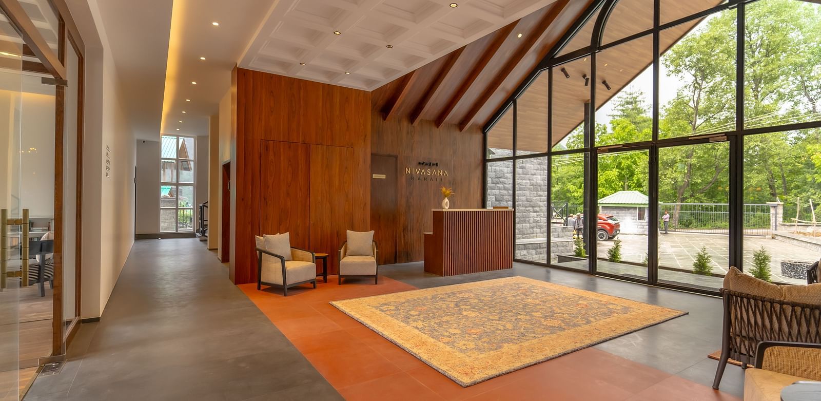 Brightly lit seating area with arched windows and colourful furnishings at Nivasana Manali.