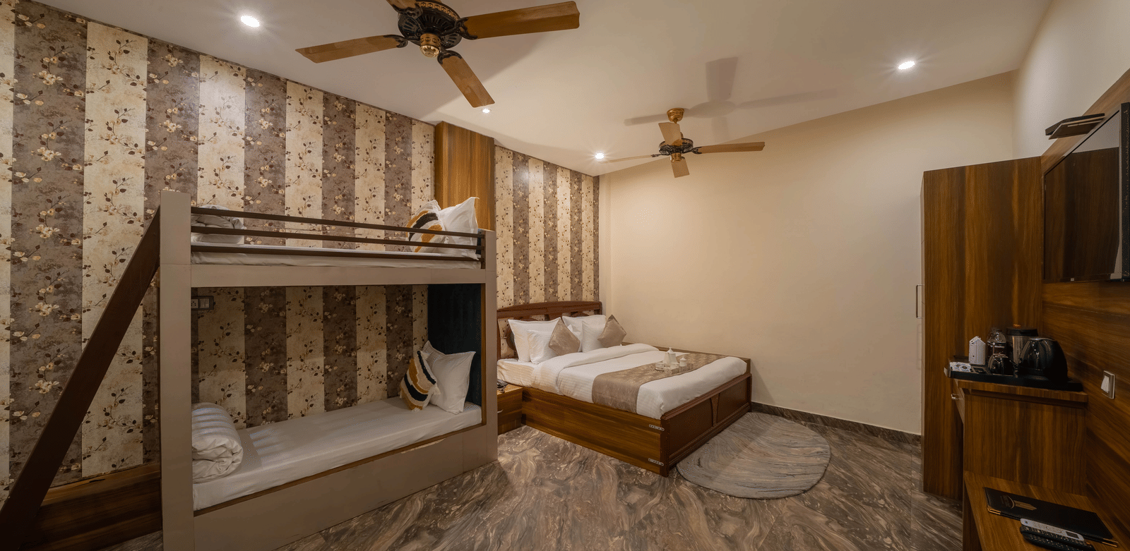 Hotel room view featuring a double bed, bunk beds, and a ceiling fan - Perfectstayz Premium at Har Ki Pauri Road (Ganga Heights)
