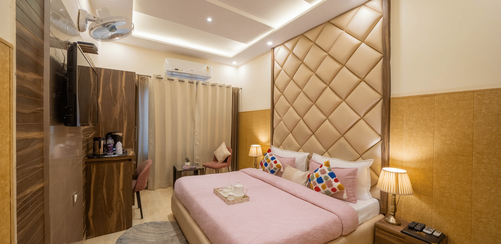 Luxurious room with a pink bed, tufted headboard, and mirrored wardrobe - Perfectstayz Premium at Har Ki Pauri Road (Ganga Heights)