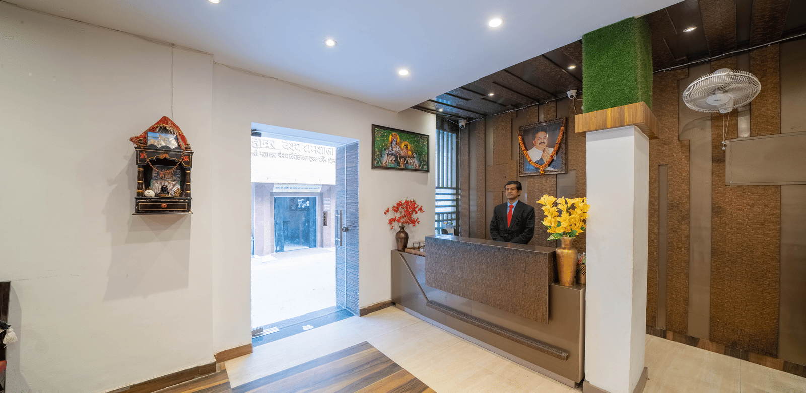 Hotel reception area with a check-in desk, warm lighting, and wood panelling - Perfectstayz Premium at Har Ki Pauri Road (Ganga Heights)
