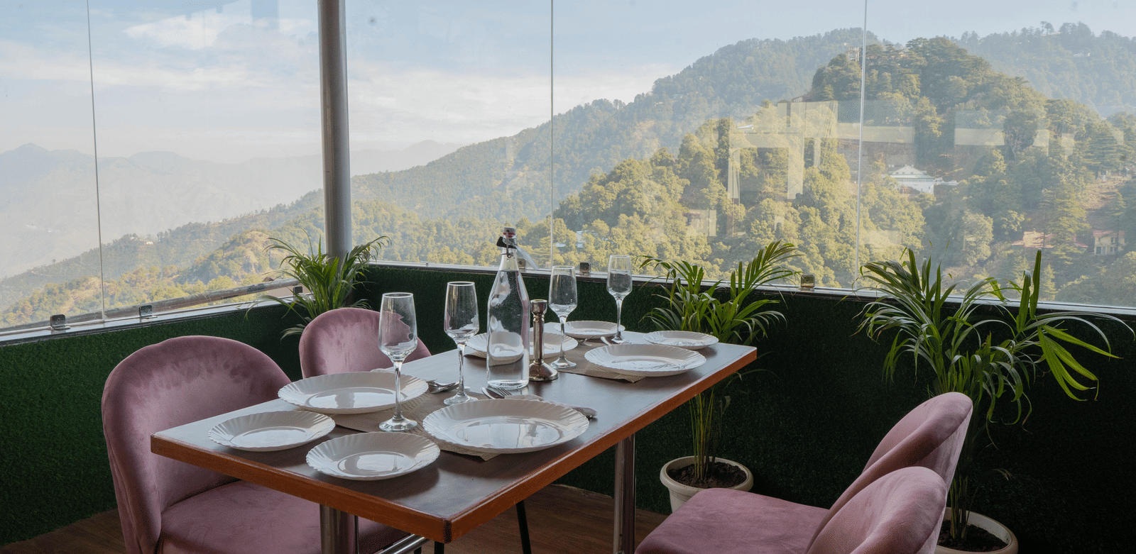 A dining setup with chairs and table facing mountain view at Perfectstayz Premium at Mall Road Hotel Super, Mussoorie.