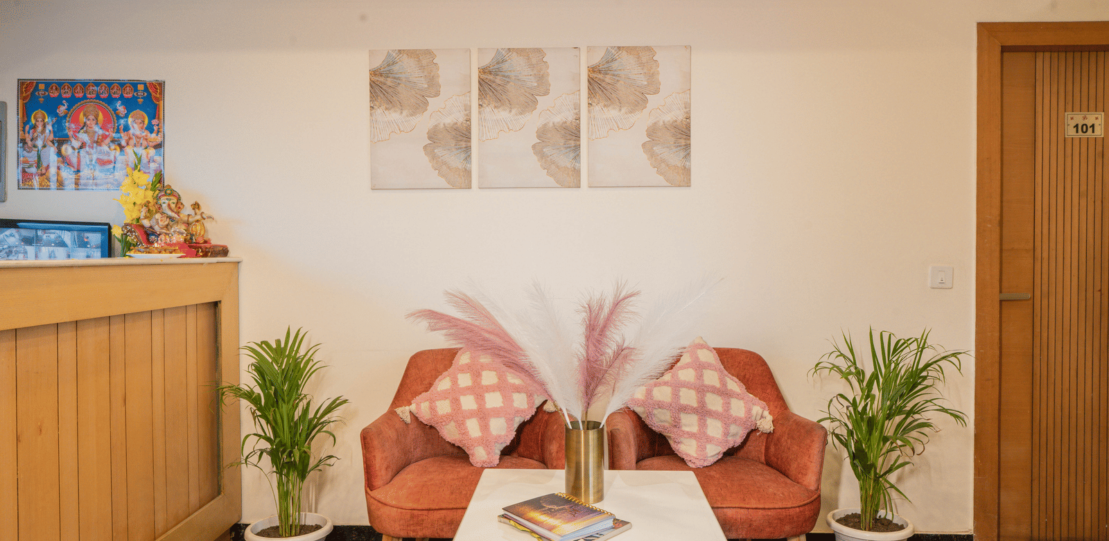 A seating area with chairs, table, and wall art at Perfectstayz Premium at Mall Road Hotel Super, Mussoorie.