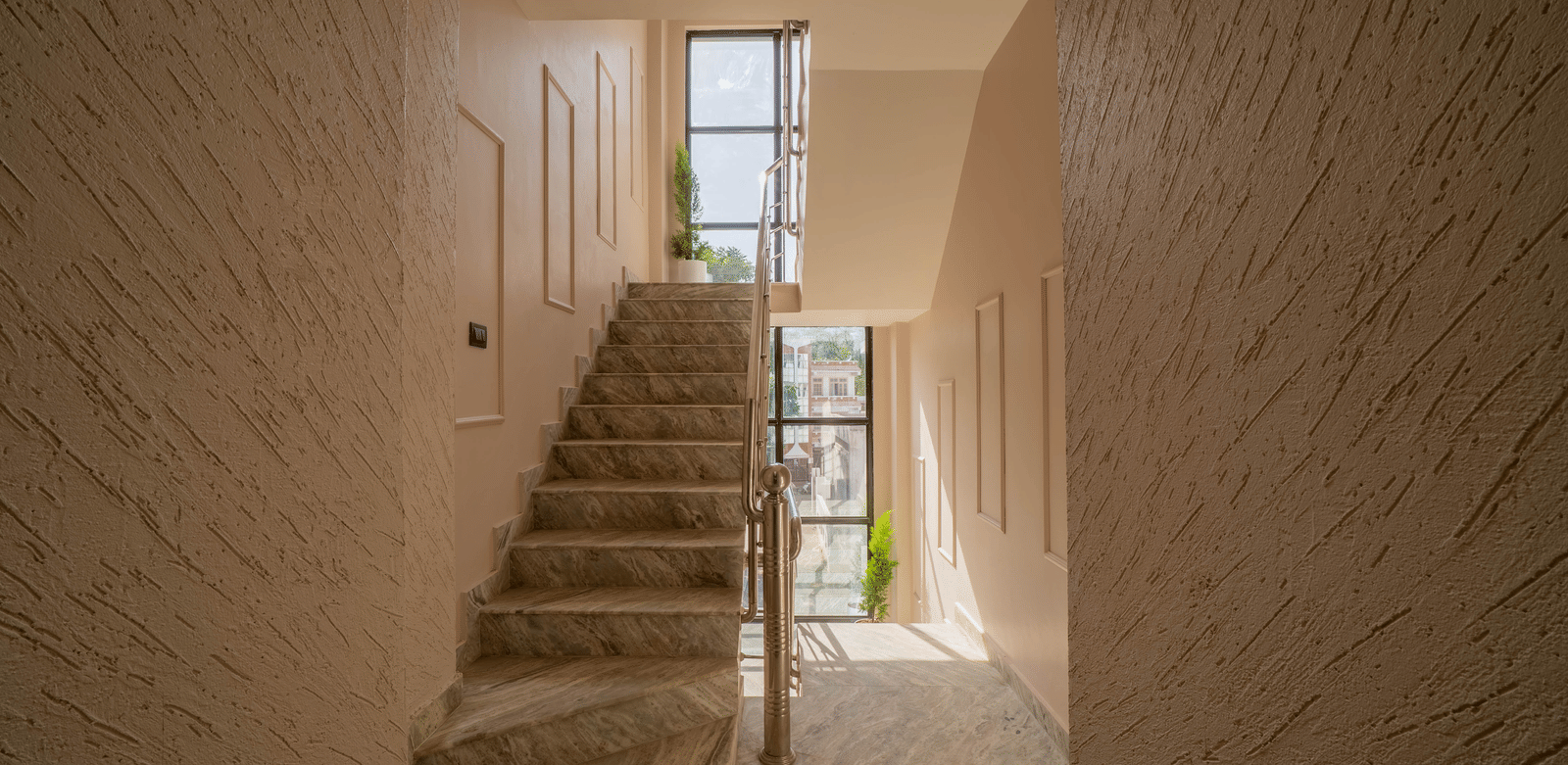 Stone staircase leading up, with natural light entering from a window - Perfectstayz Value Aalaya Suites, Haridwar