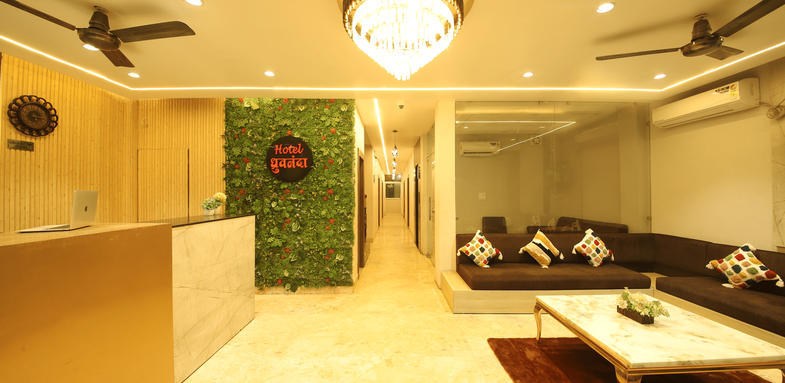Full-view shot of the lobby area featuring a waiting lounge along with the front desk at Perfectstayz Value Dhruv Nanda.