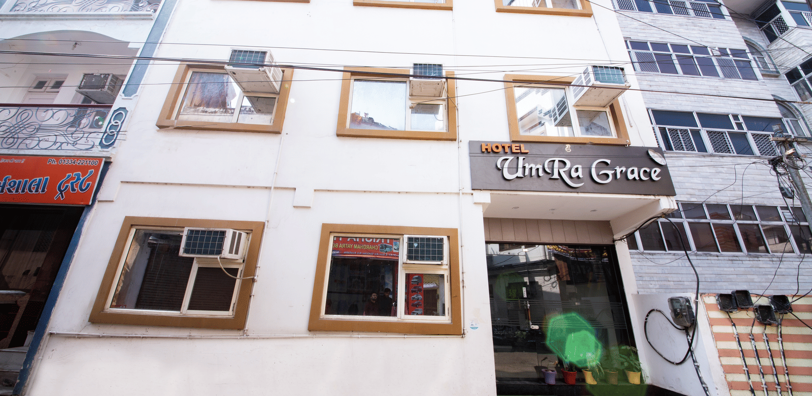 Exterior view of the multi-story hotel building with many windows - Perfectstayz Value Umra Grace, Haridwar