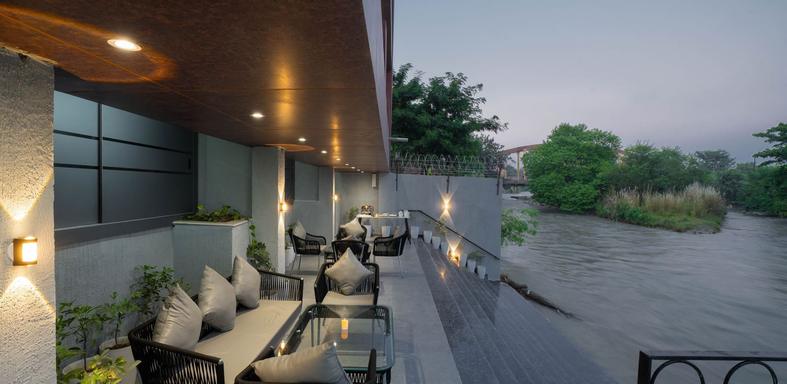 Comfortable outdoor seating area overlooking the river, perfect for relaxing at Sukoon by the Ganges.