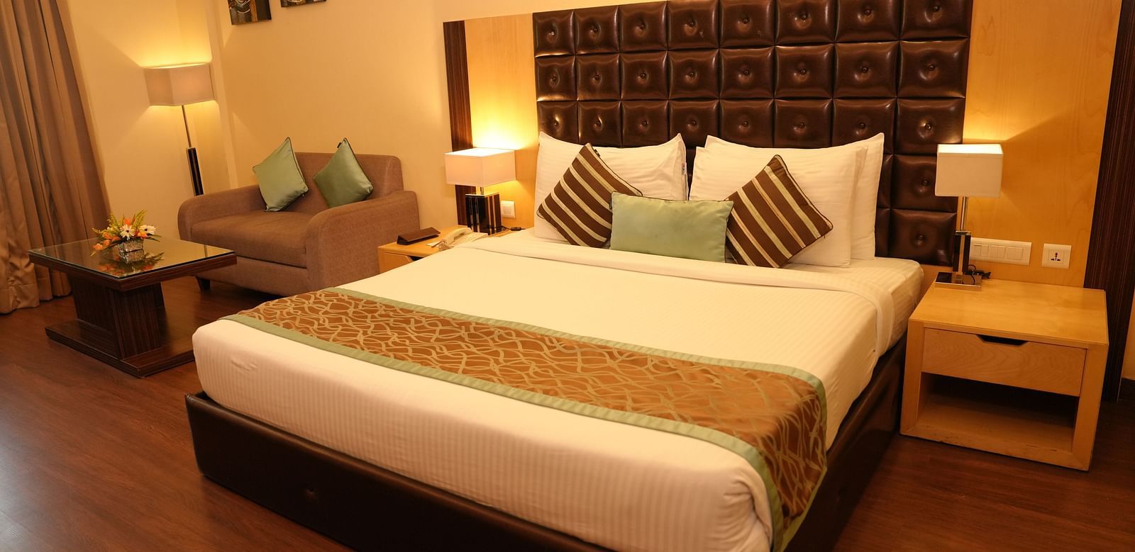 Comfortable hotel room with double bed and warm lighting - Grand Plaza Lords Inn Jammu