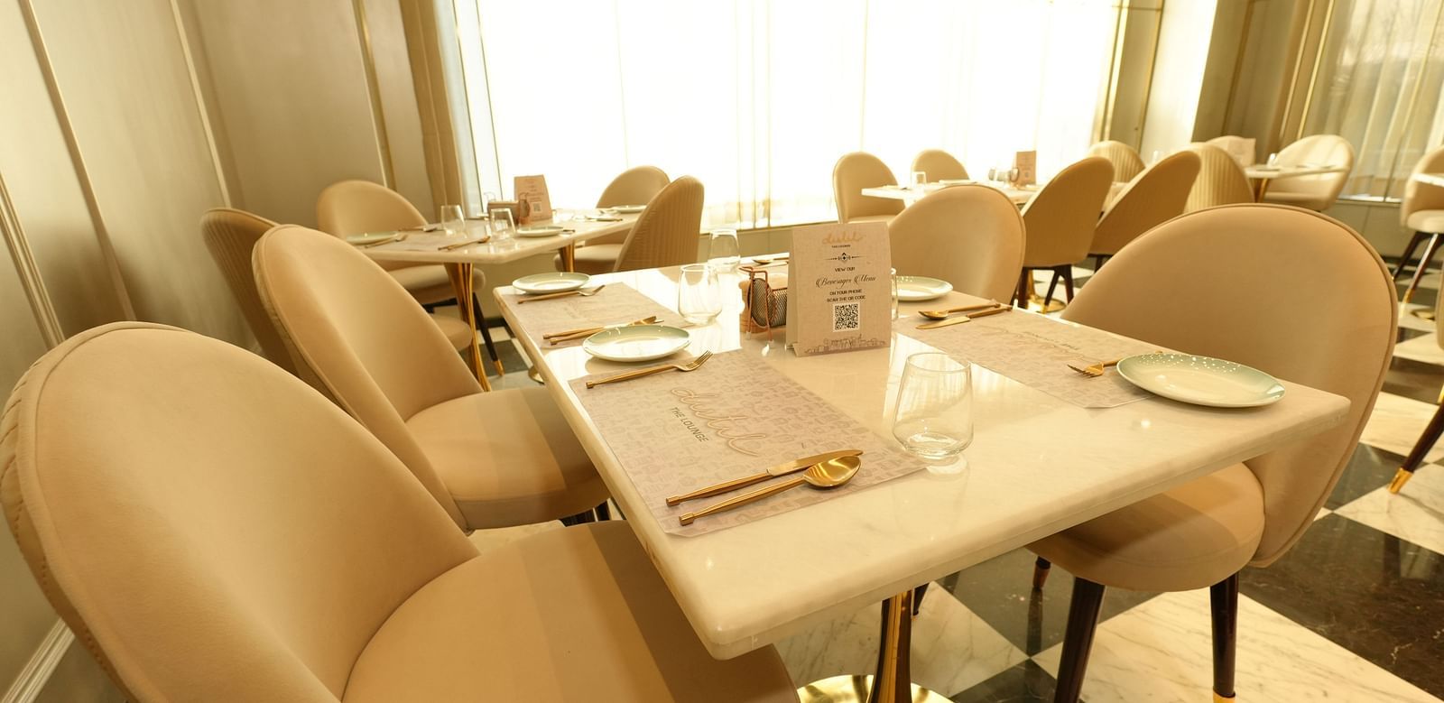 Cozy dining table set for two in a sunlit restaurant - Grand Plaza Lords Inn Jammu