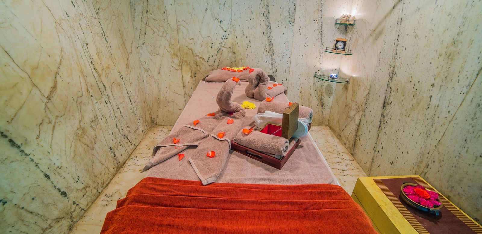 Massage bed covered with comfortable blanket at our spa at Tara, Comfort Hotel in Hyderabad - Ramoji Film City.