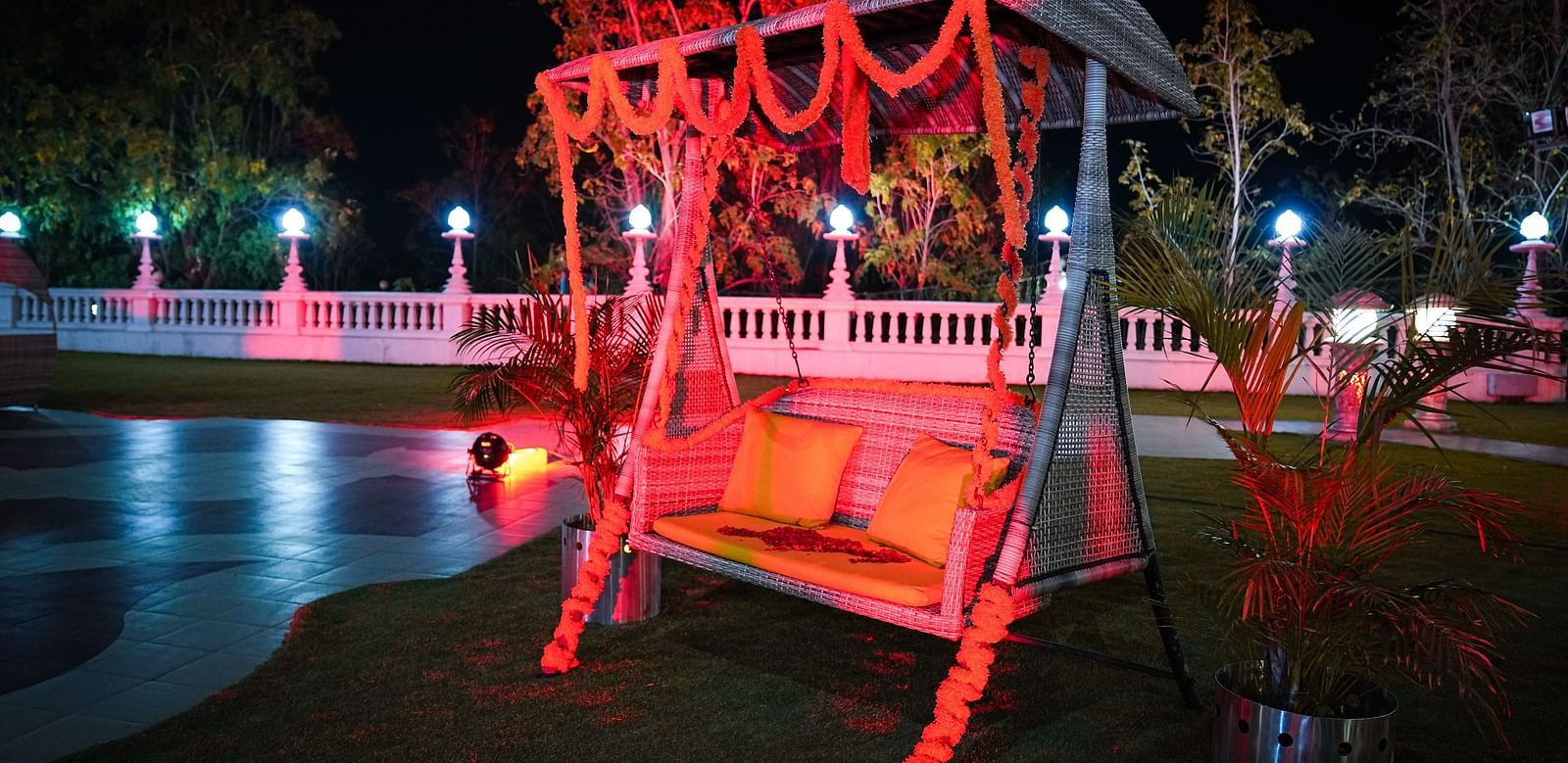a side angle of  swing on a lawn at night - Ramoji Film City Hotels in Hyderabad 