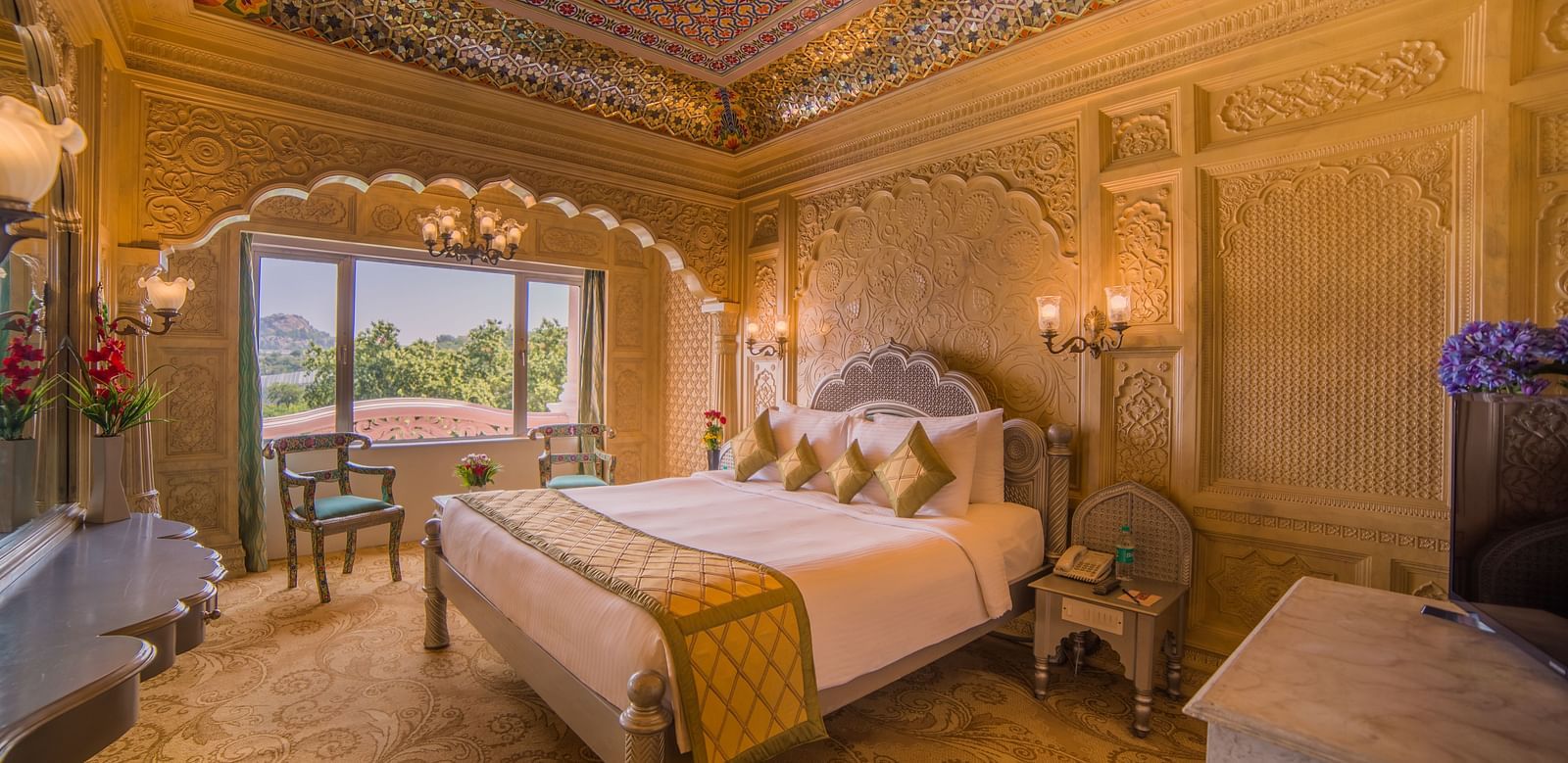 A beautifully decorated hotel room with a domed ceiling and scenic views, perfect for a luxurious stay at  Sitara Luxury Hotel in Hyderabad near Ramoji Film City.