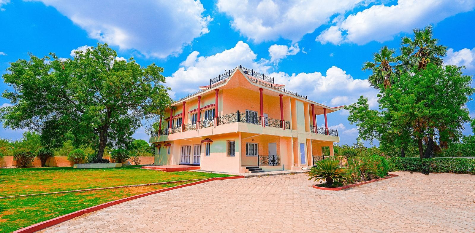 Exterior view of Vasundhara Villa on a cloudy day