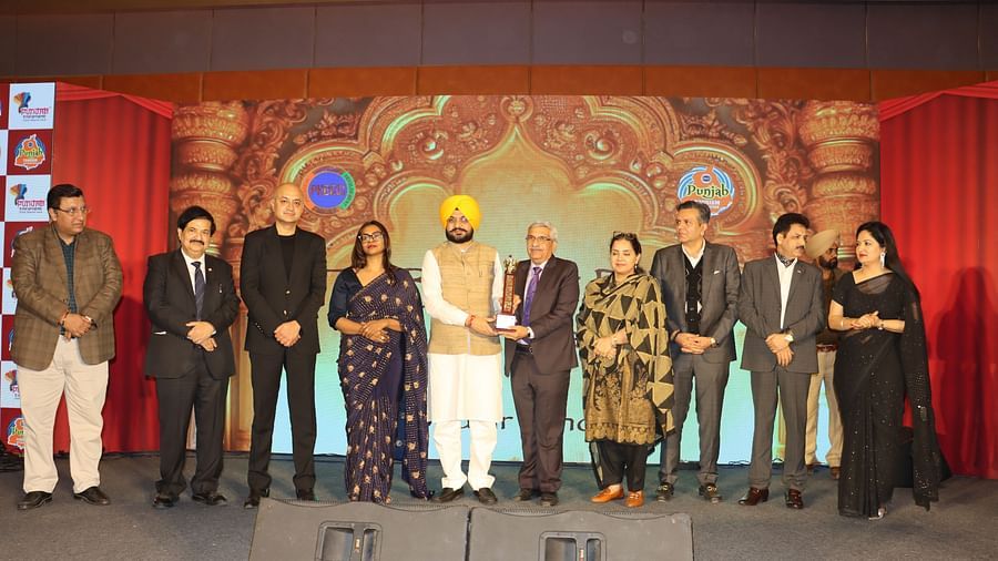 A group of people on a stage with ambient lighting and professional attire during an award ceremony