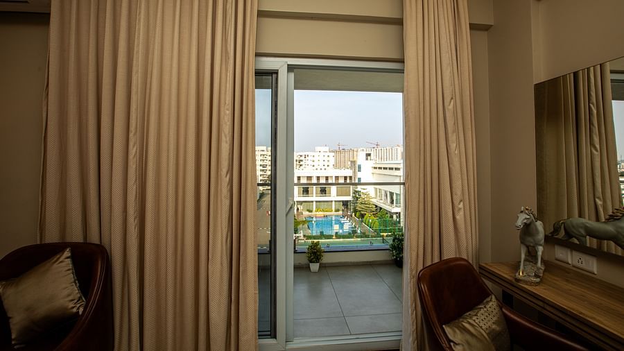 View from the room into a balcony with small plant pots