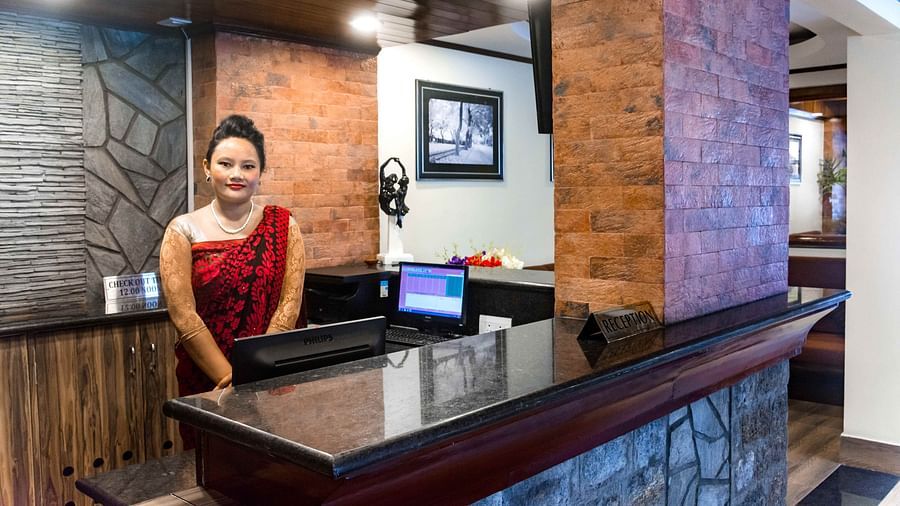 An image of the reception at the Ecotel Tin Tin, Bijanbari where a woman is seen with a welcoming smile