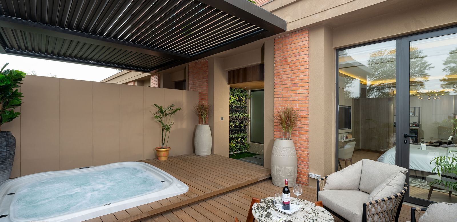 Nirvana Suite patio boasting a relaxing jacuzzi, comfortable outdoor seating, and a view of the hotel's surroundings - Nirvana Luxury Hotel, Ludhiana