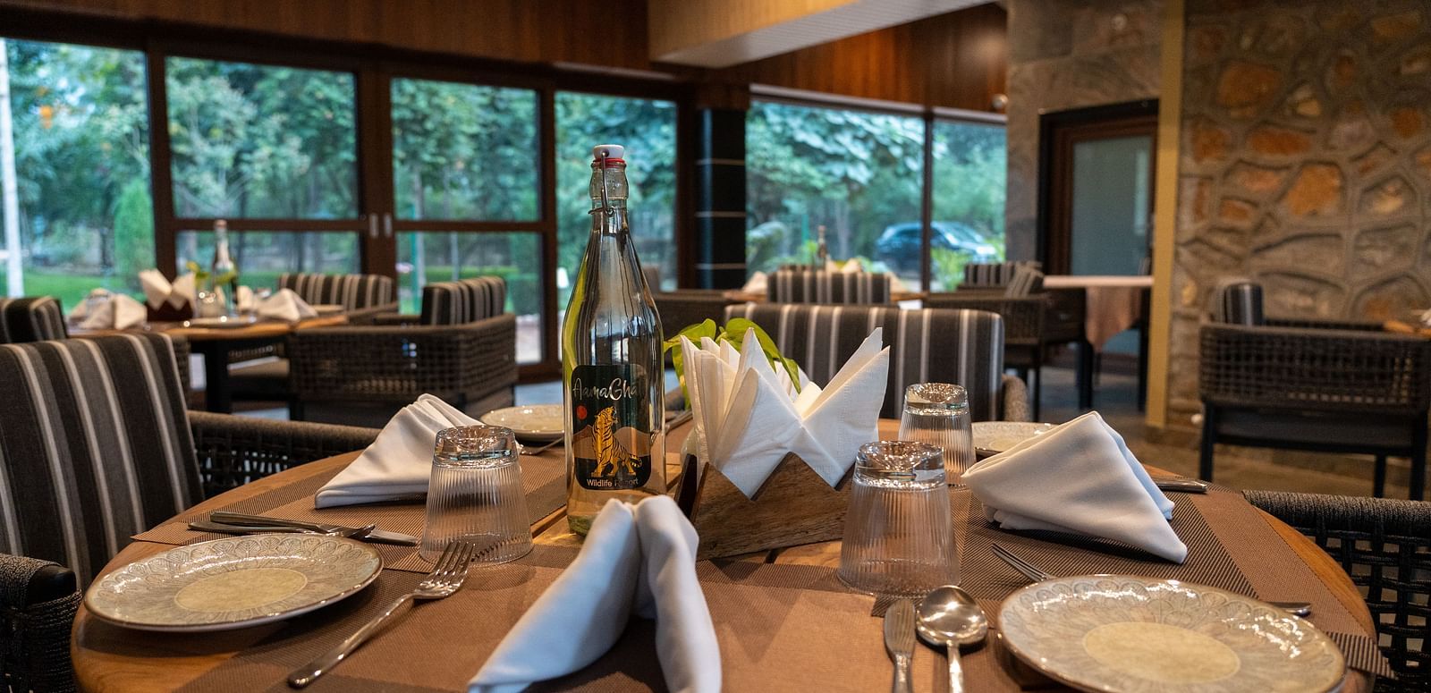 A set dining table at Aamaghati Jungle Retreat Ranthambore ready for guests with elegant place settings.