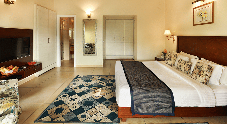 Full angle view of Super deluxe room featuring a white cupboard and other room amenities like a television, a tea & coffee maker, among others - Lamrin Norwood Green, Palampur