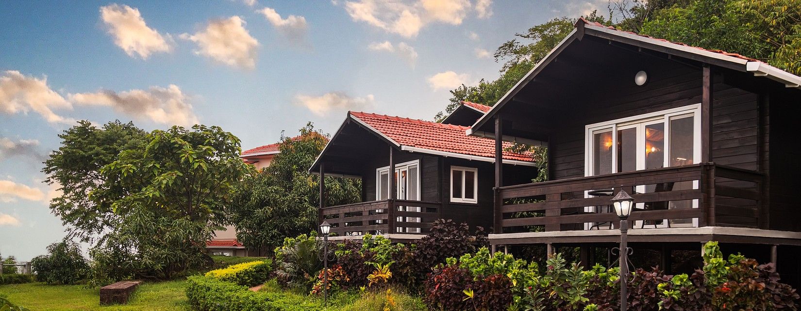 Quaint accommodations at our resort surrounded by lush greenery - Highland Sarovar Portico, Sindhudurg