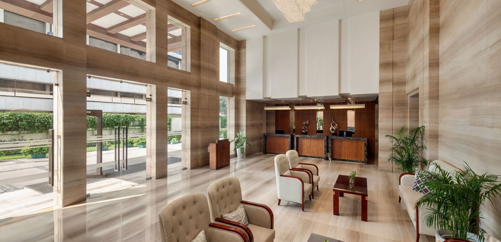 Hotel lobby seating area with comfortable furniture and natural light at Ramada by Wyndham Ghaziabad Vasundhara