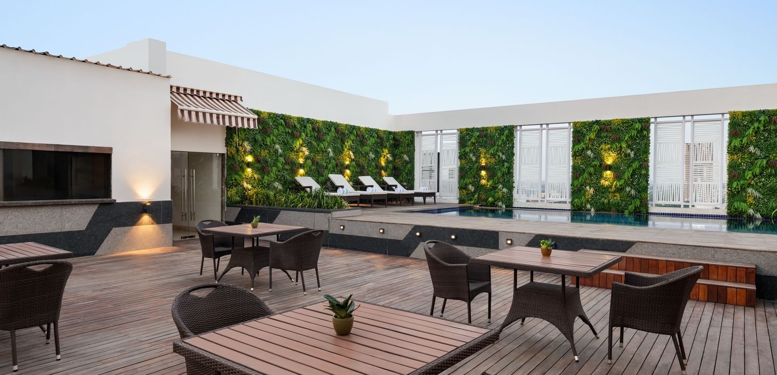 Rooftop terrace dining area with outdoor seating and city views at Ramada by Wyndham Ghaziabad Vasundhara