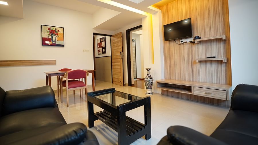 an image of a living space with a television in a suite at  City Centre Residency, Bangalore