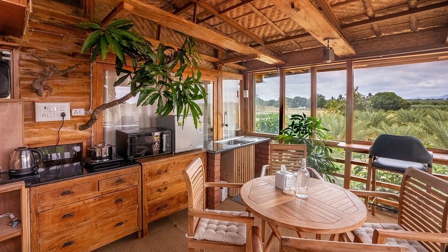Close up view of Roof top seating area with wooden chairs  and table