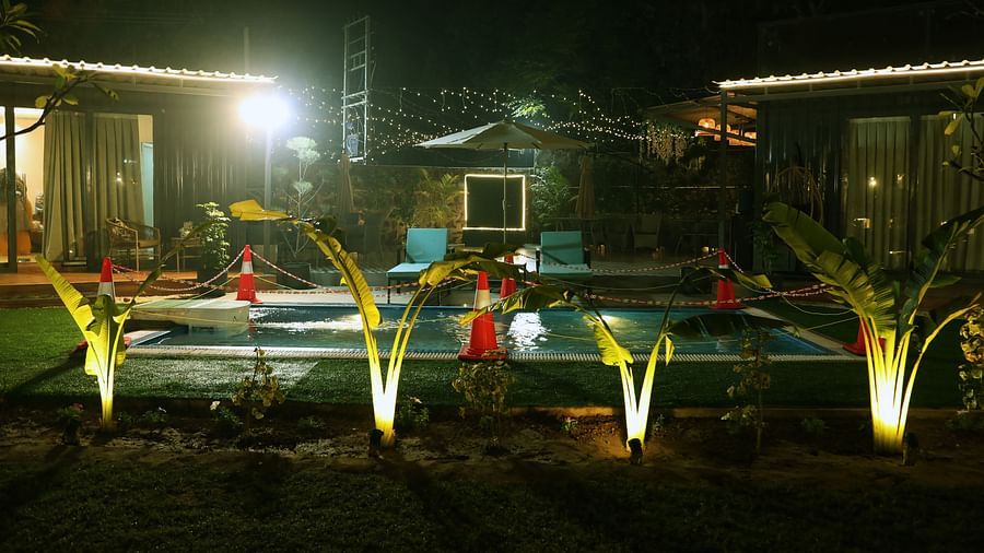 Night view of garden lighting and building exterior at Tisya Farms, Gurgaon.