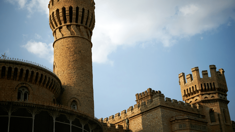 Historic stone tower with detailed architecture against a blue sky.