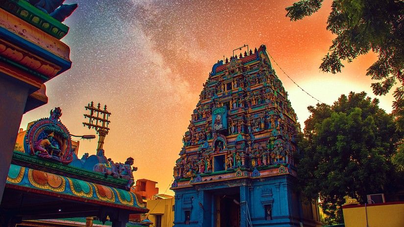 Image of a hindu temple decorated with vibrant colours during daytime