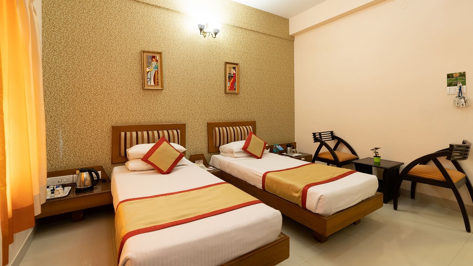 Twin bed with chairs next to it inside one of the rooms - Hotel Pai Vista, KR Road