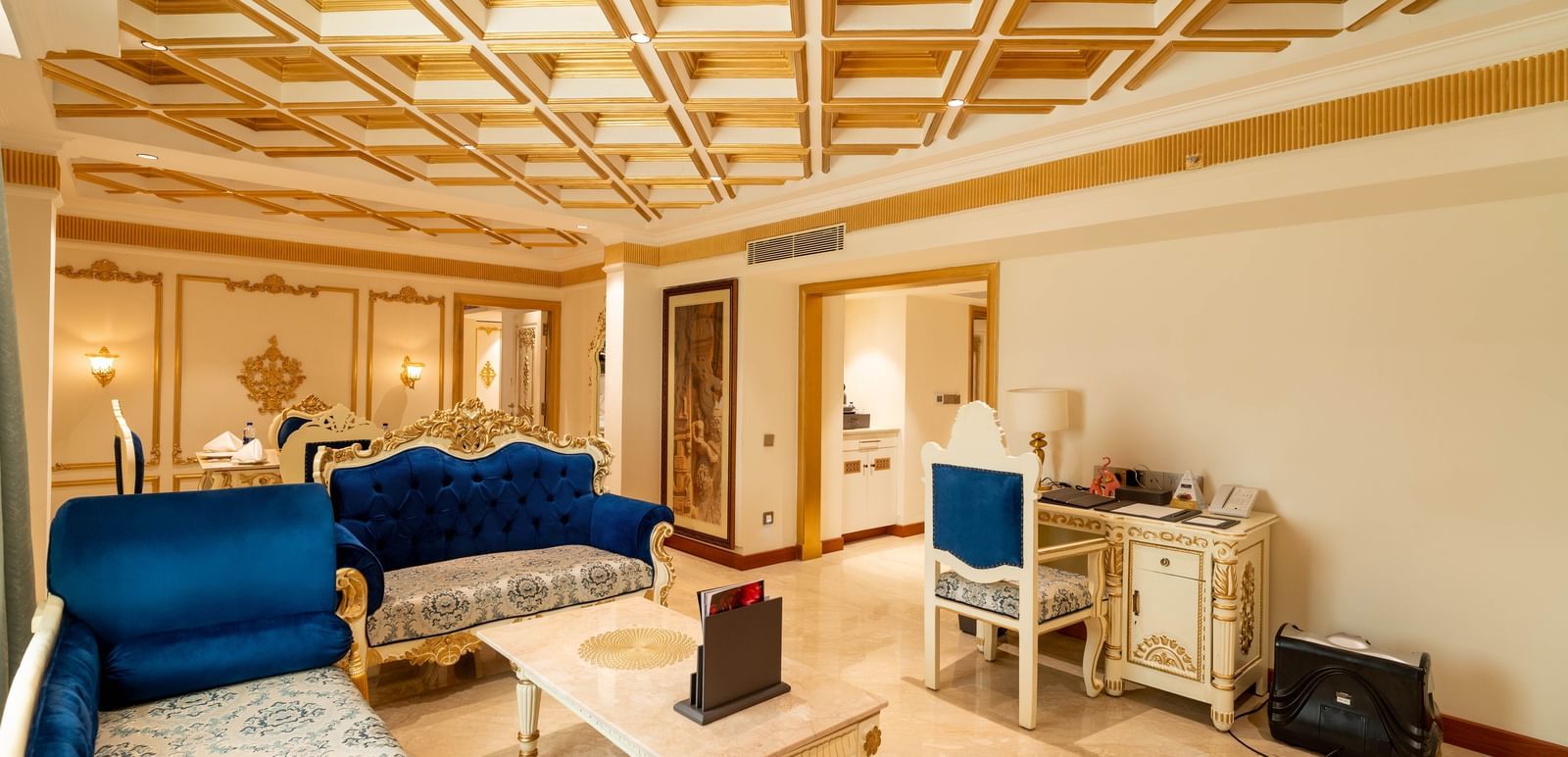 Living area at Accord Metropolitan with blue sofas and ceiling detail.