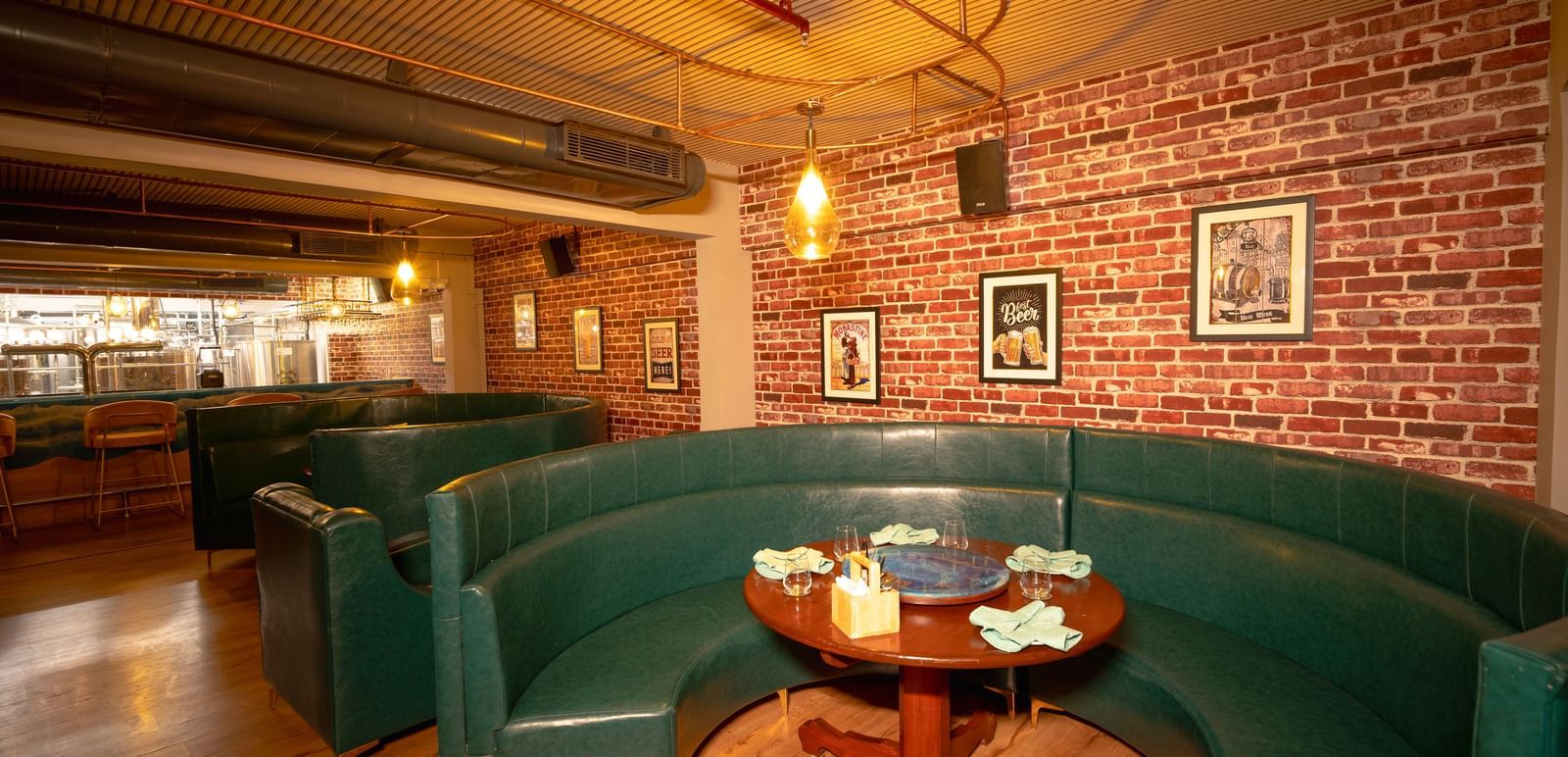 A cosy corner at our bar featuring a green coloured sofa and a coffee table - Accord Puducherry
