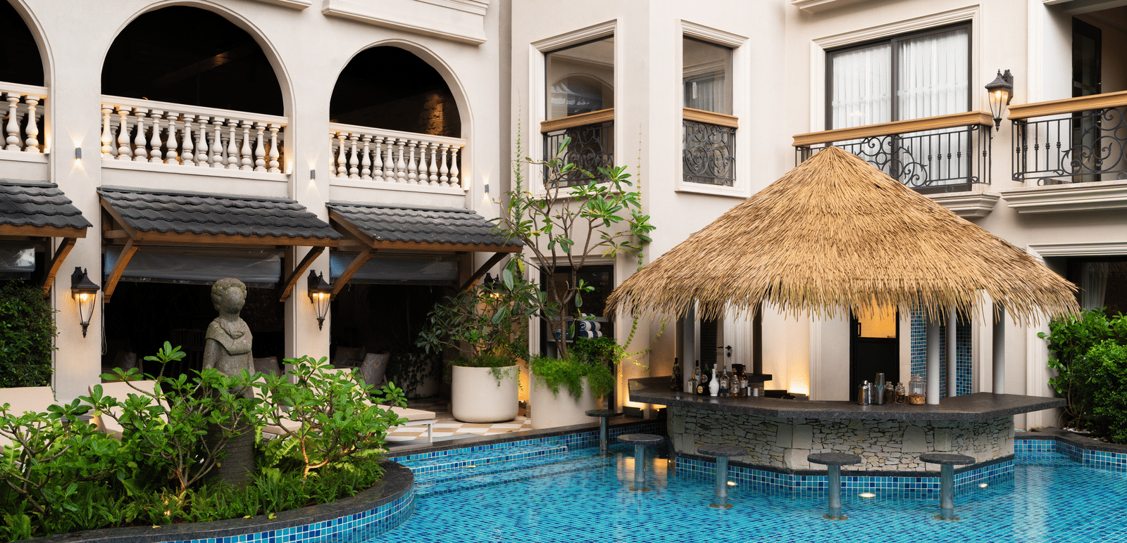 Side-view shot of the Splash Pool Bar with thatched roof above it at The Evren, Vagator.