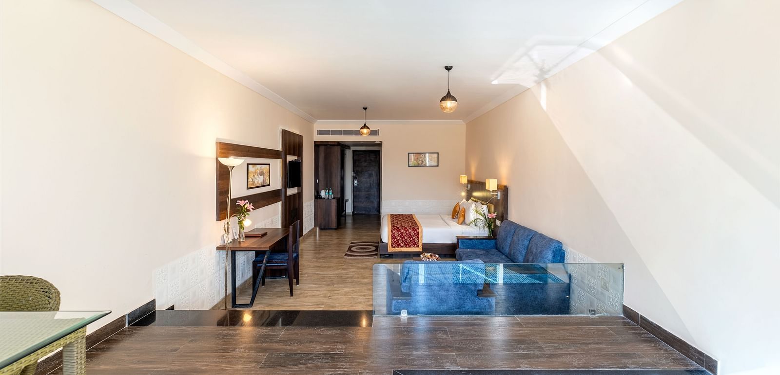 A hallway with a door leading to a room with small plunge pool - Via Lakhela Resort & Spa