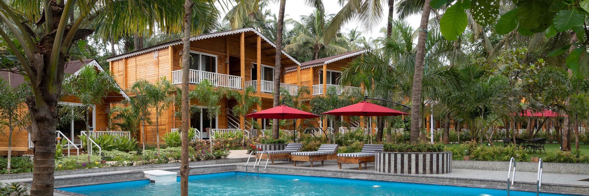 A view of the swimming pool area, showcasing the detailed landscaping and inviting poolside environment Aralea Beach Resort by Stone Wood, Morjim