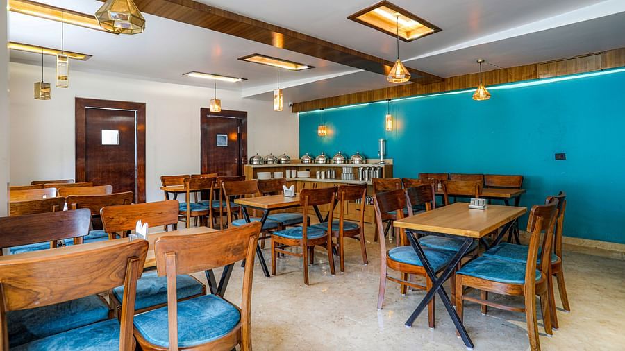 Family restaurant at Vinsober Monal, Nainital, with tables, chairs and buffet area 