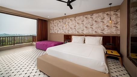 An image showcasing a spacious bedroom with elegant interiors and modern amenities at Crescent Resort, Goa