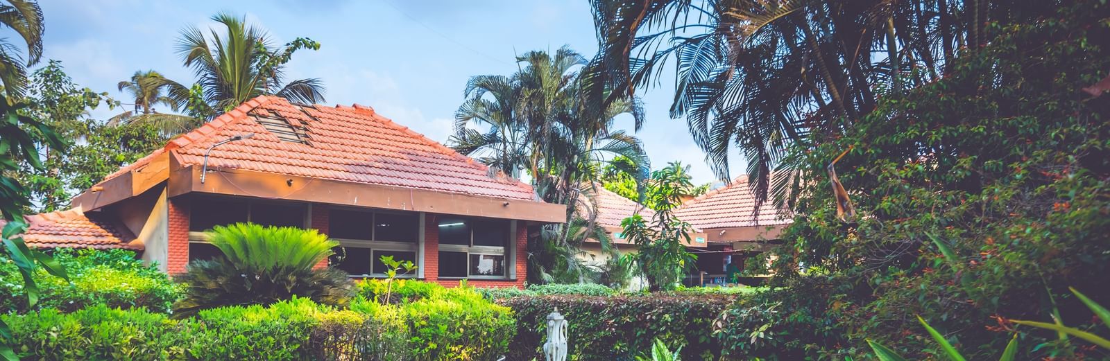Lush garden with a small decorative fountain at Paradise Isle Beach Resort. 